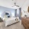 spacious bedroom with ceiling fan and light fixture